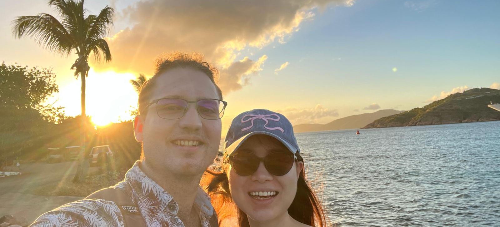 Sharon and Tomasz at sunset under a palm tree