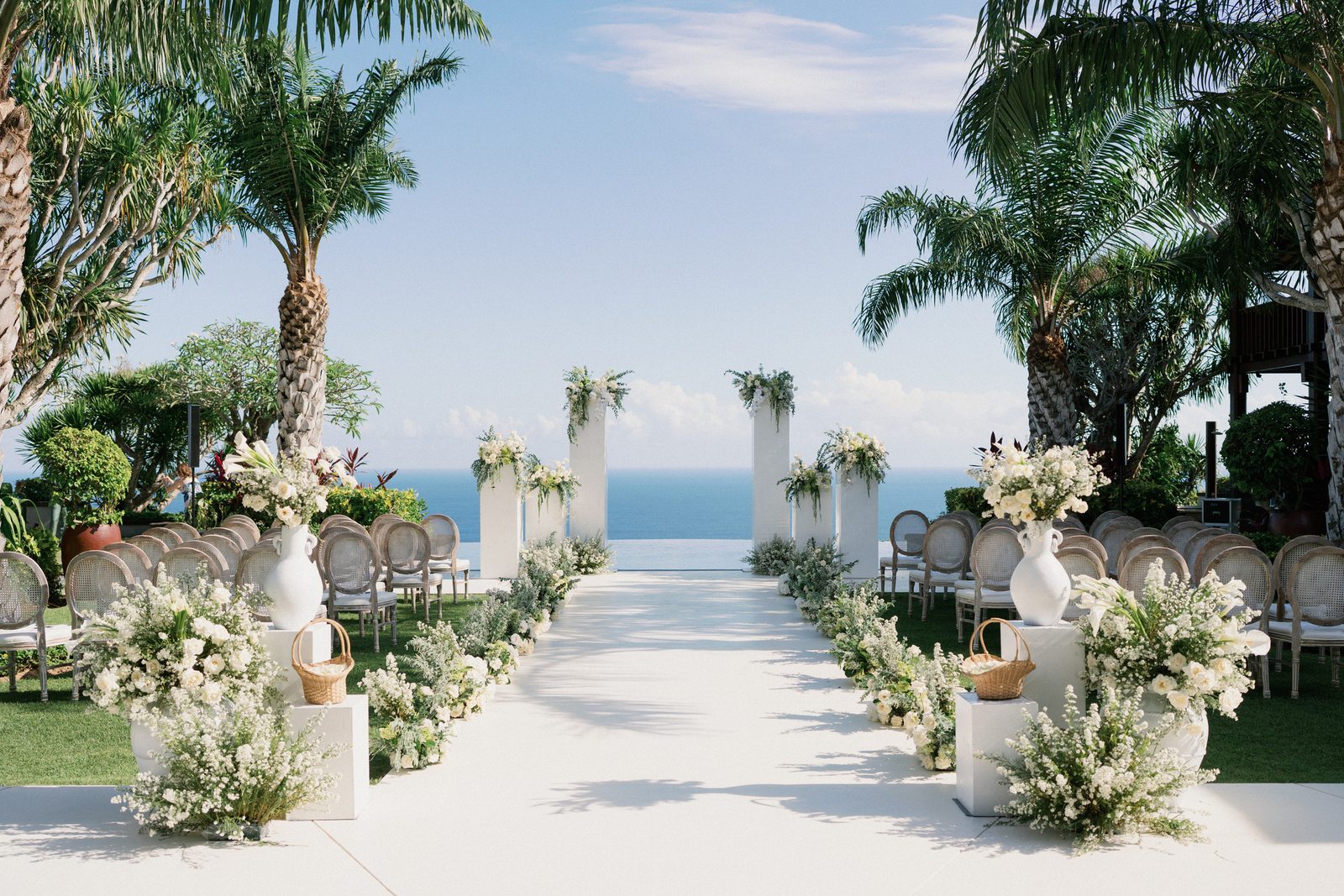 Ceremony aisle set with florals, facing the ocean